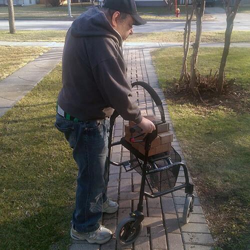 Robert moving bricks to garden